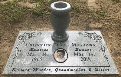 single gray granite headstone with rose design and portrait